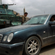 Yemeni soldiers search a car Sunday at a checkpoint on a street leading to the U.S. Embassy. (Mohammed Huwais/AFP/Getty Images)
